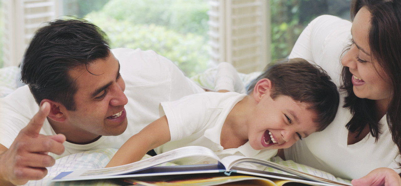 Parents Reading to Laughing Boy